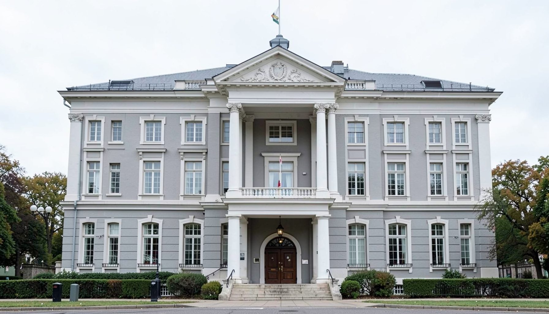 A stately government building in muted grey and white tones with a formal and restrained mood